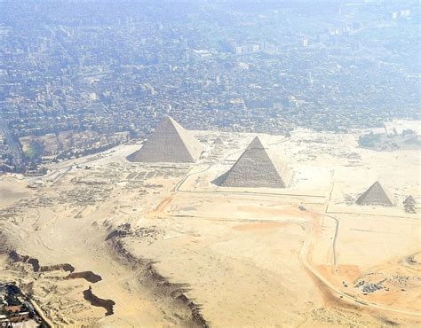 The Great Pyramids rise behind Giza